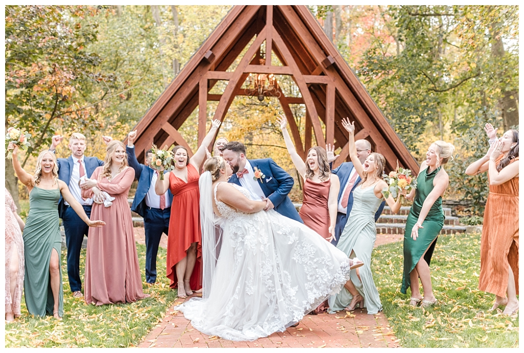 Bridal party walking through the rustic woodland landscape of The Abbey at The Stone Mill Inn, York, PA