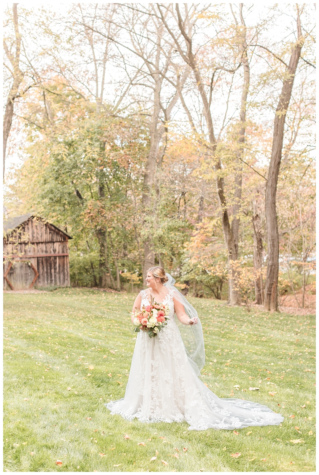 Bride walking through rustic paths of  autumn foliage