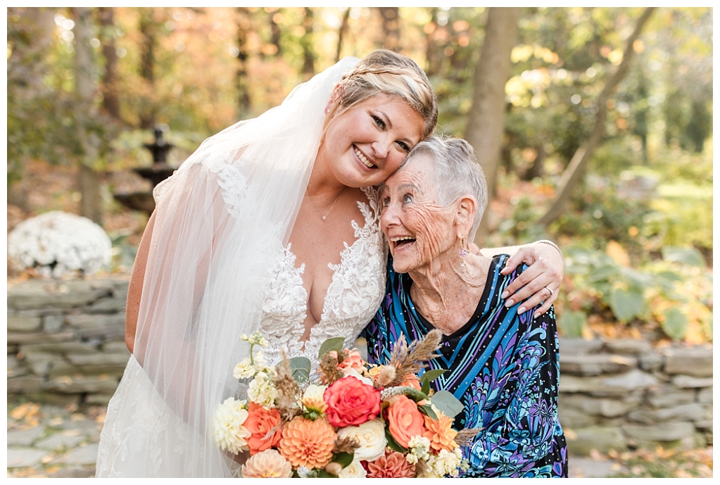 Bride and her grandmother laughing together along the stone path