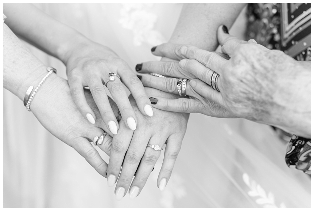 Detail shot of hands from the different generations on the female side of the bride's family.