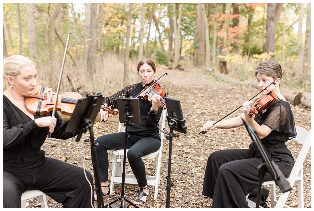 3 out of 4 players of the live string quartet playing during the wedding ceremony