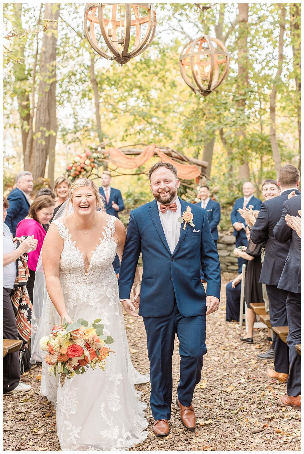 Julia and Andy walking down the aisle of their rustic autumnal wedding