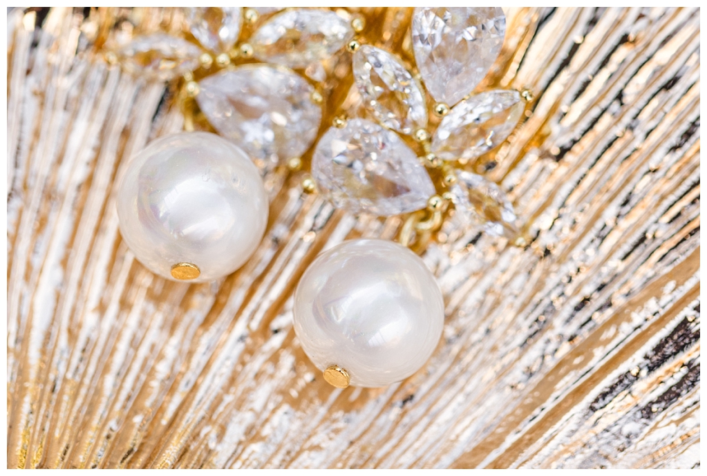 white pearl and gold wedding bridal earrings in a gold dish
